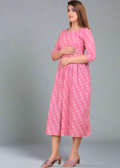 Woman wearing a pink patterned dress standing on a beige background