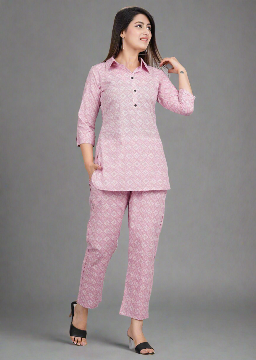 Woman wearing a pink patterned outfit on a gray background