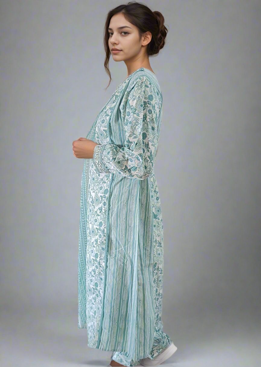 Woman wearing a light blue and white patterned suit set against a plain background