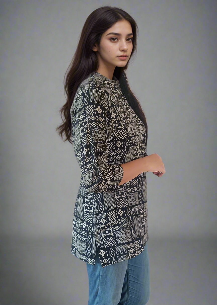 Woman wearing a patterned tunic kurti top and blue jeans on a plain background