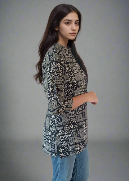 Woman wearing a patterned tunic kurti top and blue jeans on a plain background