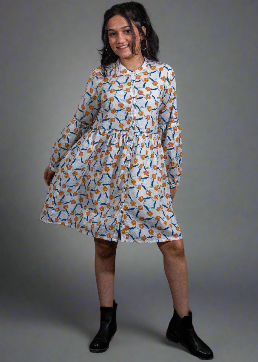 Woman wearing a hand block patterned dress against a black background