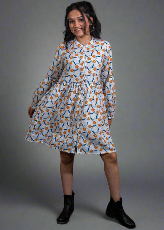 Woman wearing a hand block patterned dress against a black background