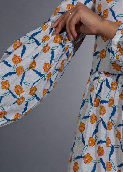 Floral patterned puffed sleeve dress with orange and blue flowers on a plain background